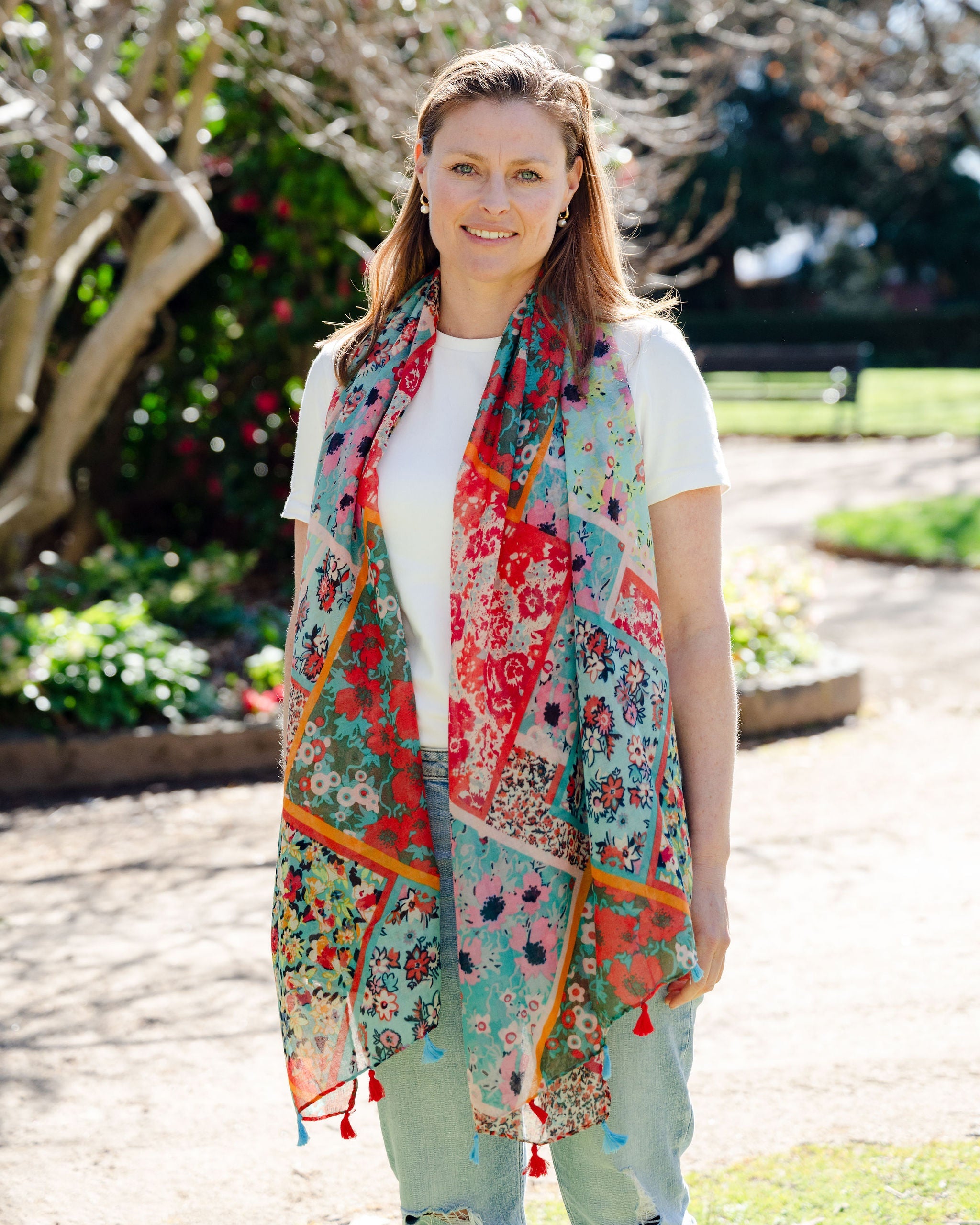 Add elegance with our unique floral and mosaic patterned scarf, adorned with red and blue tassels. Soft, lightweight, and comfortable for all-day wear. All scarves are a polyester blend. Add elegance with our unique floral and mosaic patterned scarf, adorned with red and blue tassels. Soft, lightweight, and comfortable for all-day wear. All scarves are a polyester blend.