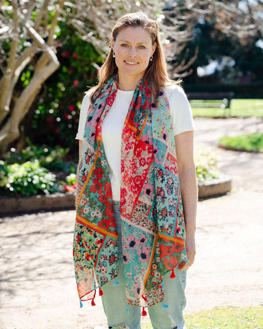 Add elegance with our unique floral and mosaic patterned scarf, adorned with red and blue tassels. Soft, lightweight, and comfortable for all-day wear. All scarves are a polyester blend. Add elegance with our unique floral and mosaic patterned scarf, adorned with red and blue tassels. Soft, lightweight, and comfortable for all-day wear. All scarves are a polyester blend.