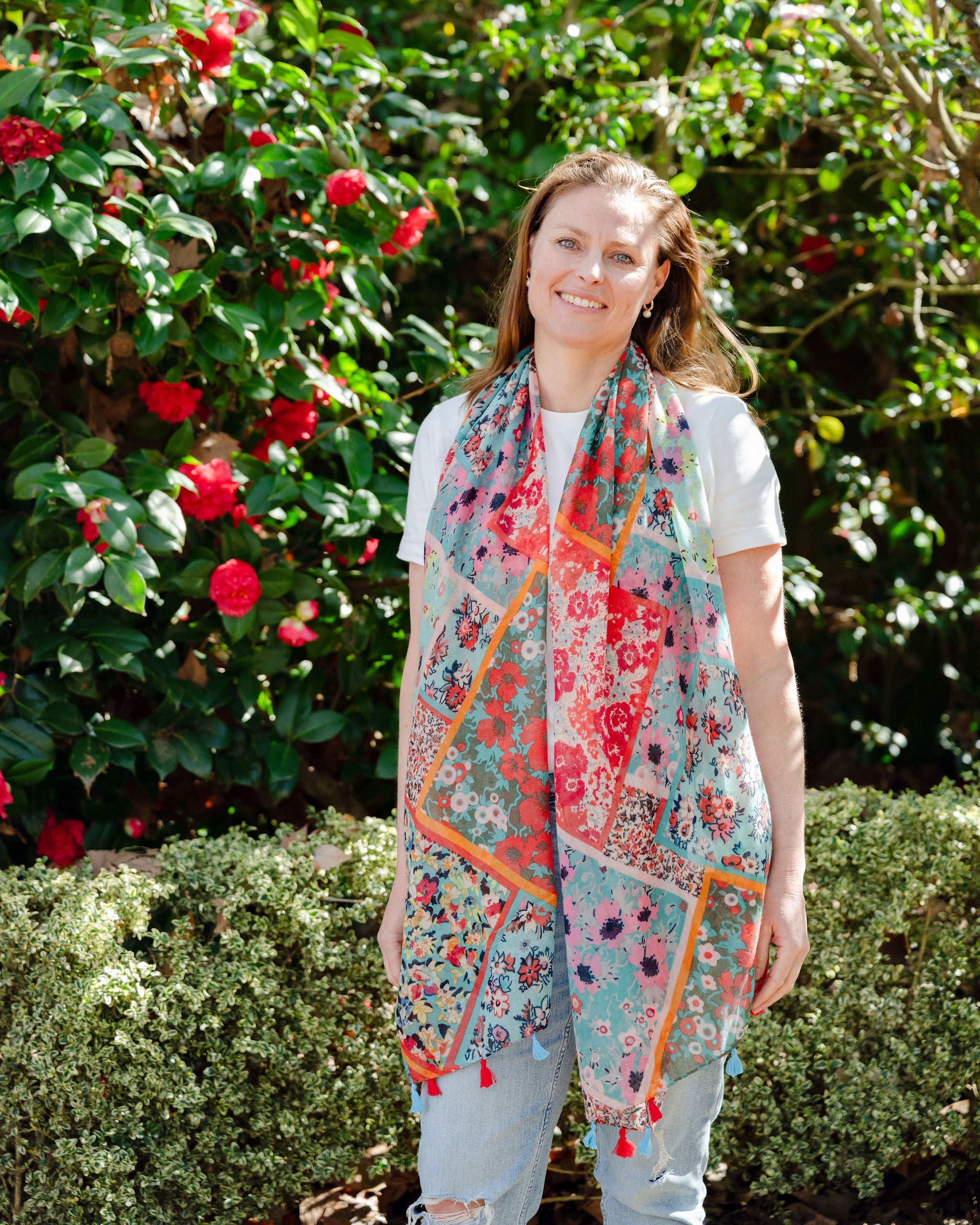 Add elegance with our unique floral and mosaic patterned scarf, adorned with red and blue tassels. Soft, lightweight, and comfortable for all-day wear. All scarves are a polyester blend. Add elegance with our unique floral and mosaic patterned scarf, adorned with red and blue tassels. Soft, lightweight, and comfortable for all-day wear. All scarves are a polyester blend.