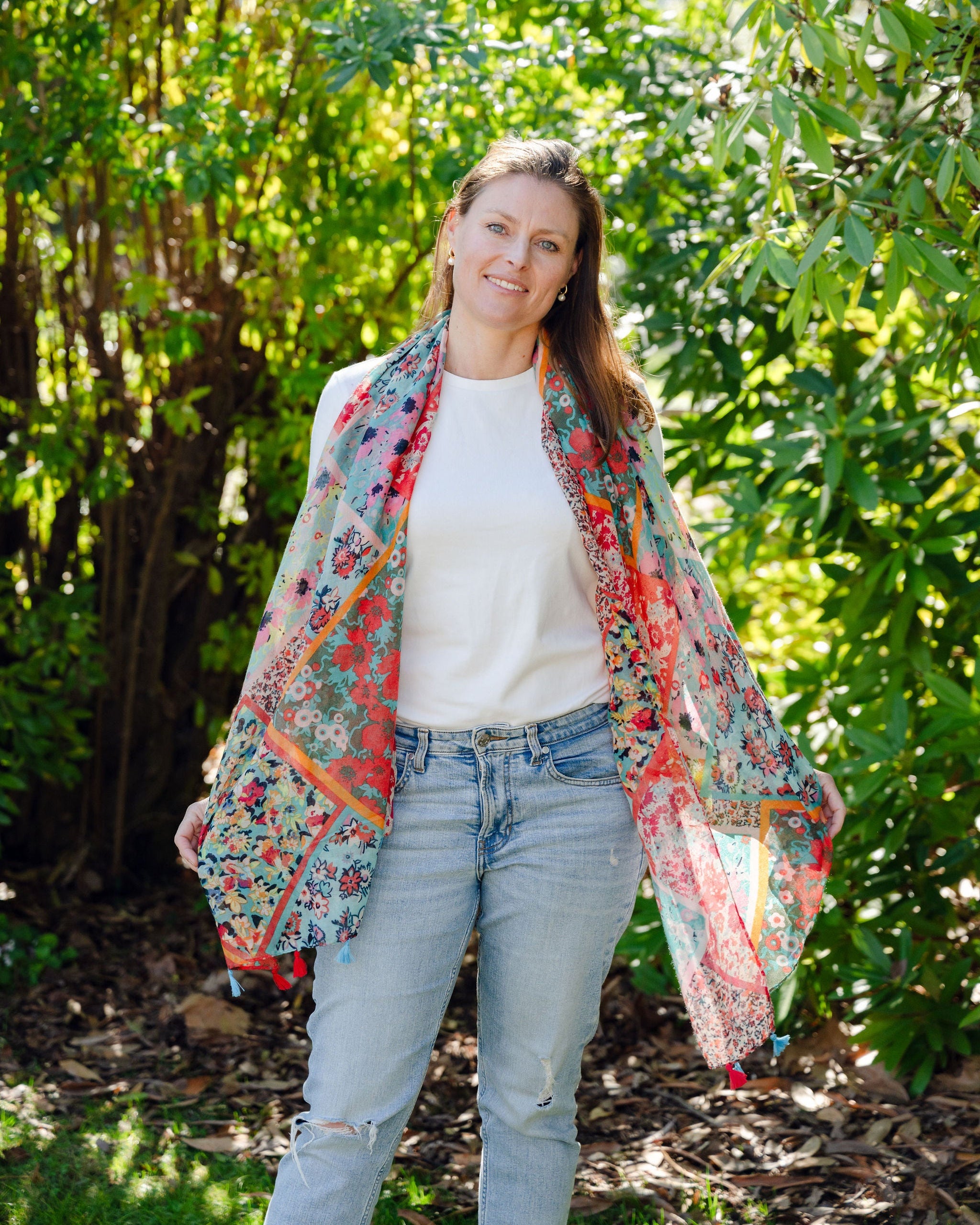 Add elegance with our unique floral and mosaic patterned scarf, adorned with red and blue tassels. Soft, lightweight, and comfortable for all-day wear. All scarves are a polyester blend. Add elegance with our unique floral and mosaic patterned scarf, adorned with red and blue tassels. Soft, lightweight, and comfortable for all-day wear. All scarves are a polyester blend.