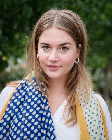 Elevate your style with our blue and off-white spot scarf, a versatile accessory that adds sophistication to any outfit. The abstract mustard border and playful tassels provide a pop of color and a finishing touch. The fresh and modern color combination makes it perfect for various outfits and occasions. Crafted from a comfortable polyester blend. Elevate your style with our blue and off-white spot scarf, a versatile accessory that adds sophistication to any outfit. The abstract mustard border and playful tassels provide a pop of color and a finishing touch. The fresh and modern color combination makes it perfect for various outfits and occasions. Crafted from a comfortable polyester blend.