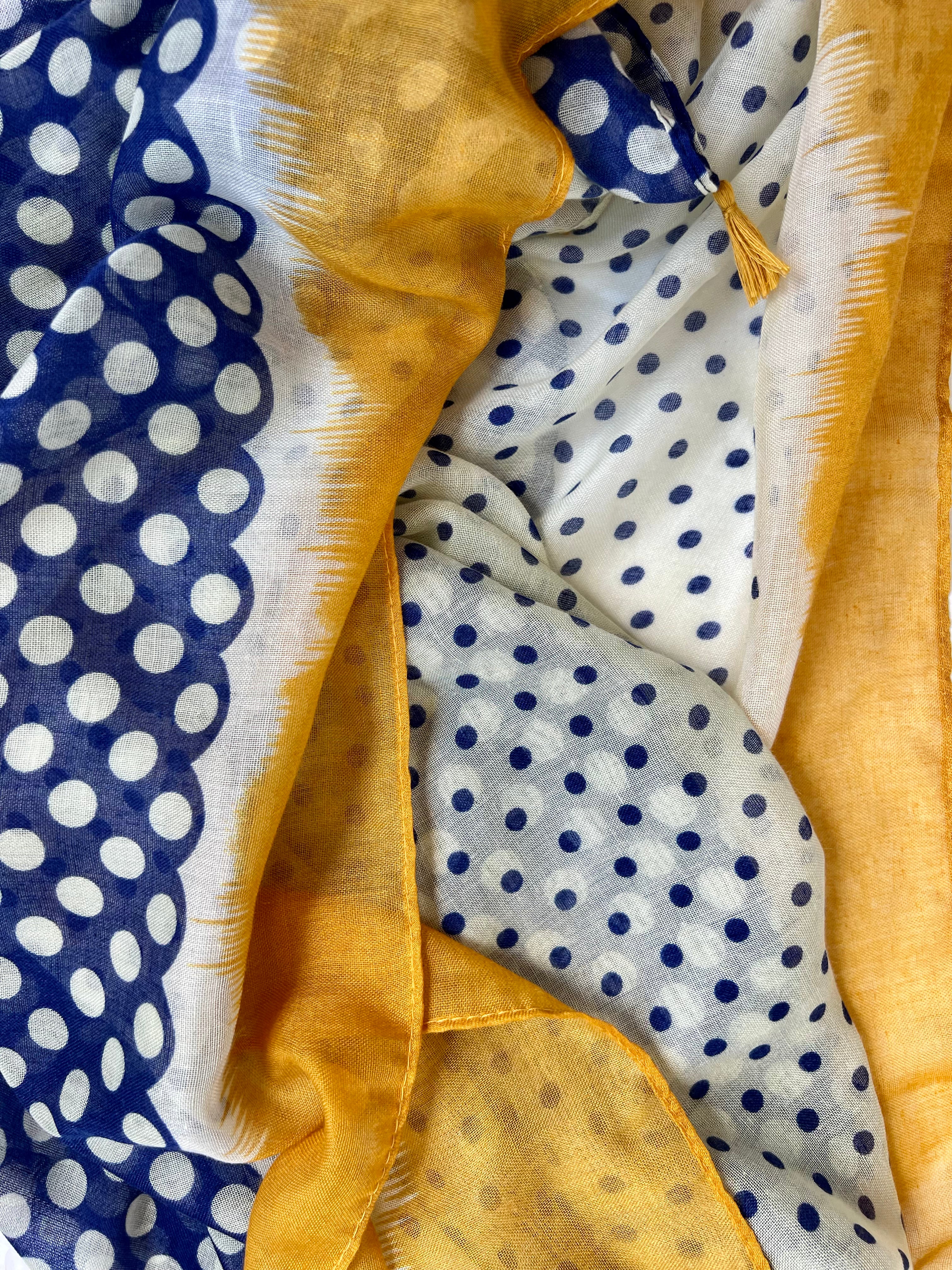 Elevate your style with our blue and off-white spot scarf, a versatile accessory that adds sophistication to any outfit. The abstract mustard border and playful tassels provide a pop of color and a finishing touch. The fresh and modern color combination makes it perfect for various outfits and occasions. Crafted from a comfortable polyester blend. Elevate your style with our blue and off-white spot scarf, a versatile accessory that adds sophistication to any outfit. The abstract mustard border and playful tassels provide a pop of color and a finishing touch. The fresh and modern color combination makes it perfect for various outfits and occasions. Crafted from a comfortable polyester blend.