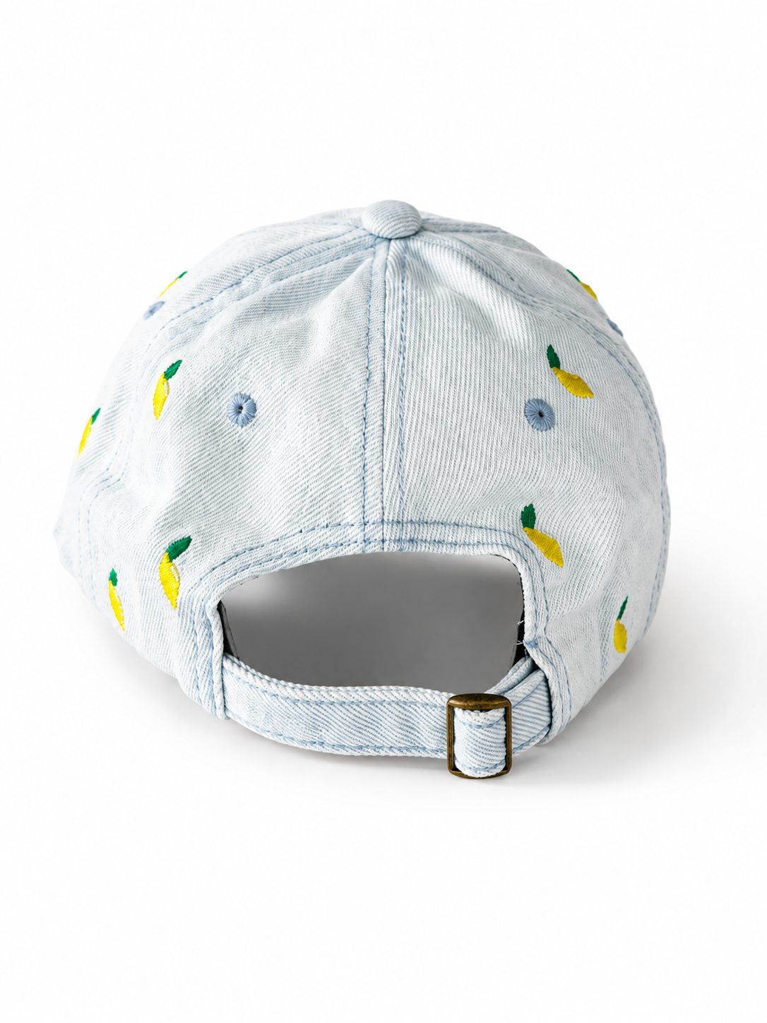 Light-wash denim baseball cap embroidered with small yellow lemons, front view on a white background.