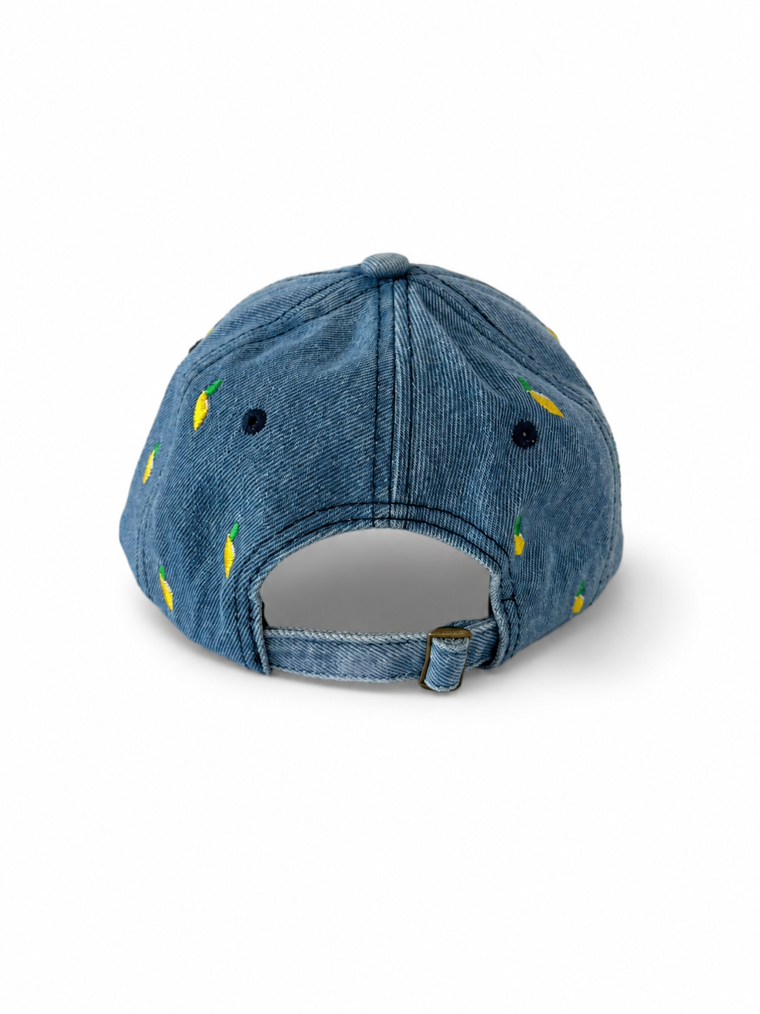 Back view of the mid-wash lemon-embroidered cap, showing the curved crown and the adjustable strap clipped into its brass buckle.