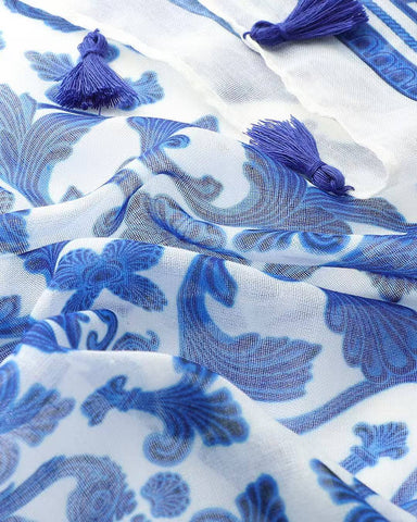 Close-up of blue and white damask print scarf with navy tassels