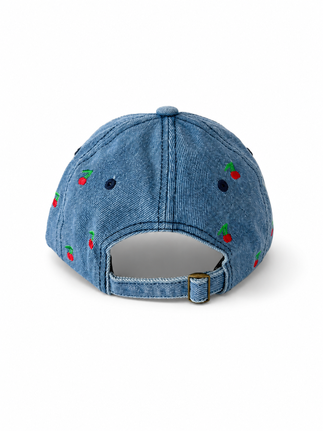 Back view of the mid-wash cherry-embroidered cap, showing the curved crown and the adjustable strap clipped into its brass buckle.