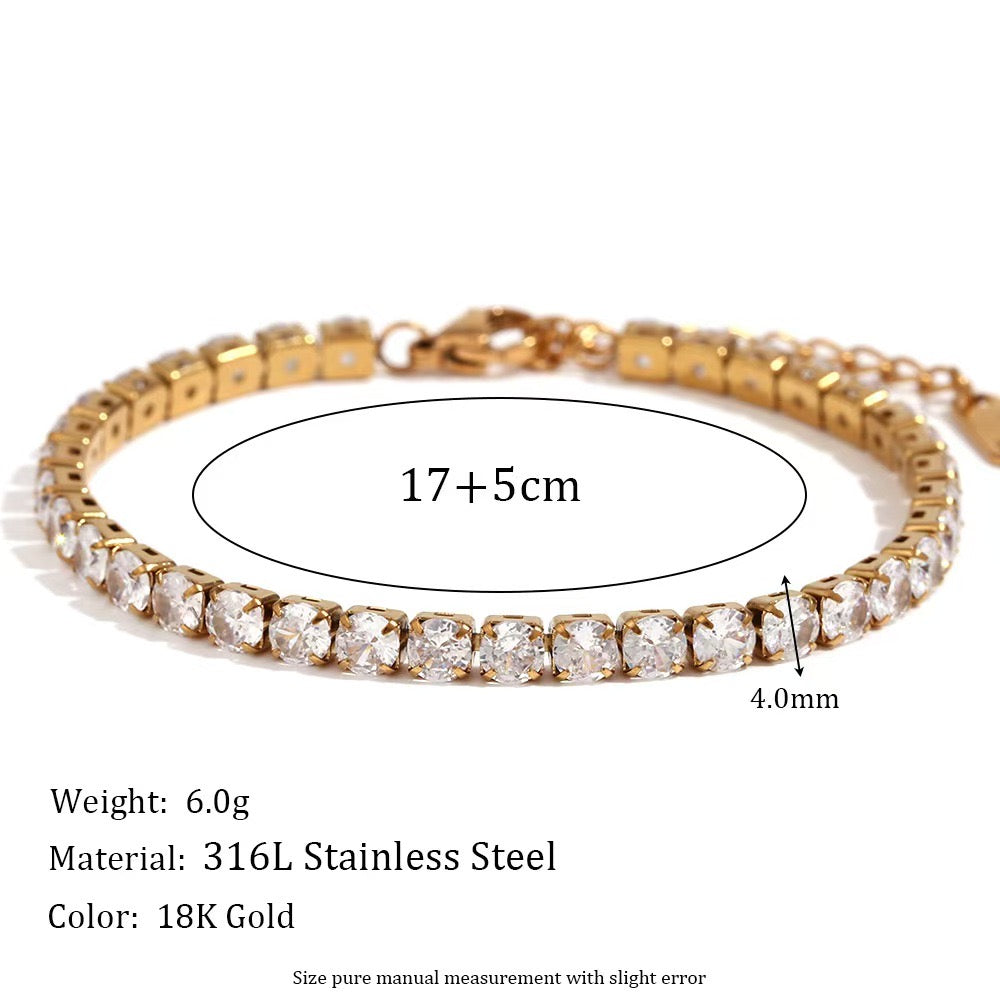 Close-up of the gold tennis bracelet's crystal stones and clasp on a white background.
