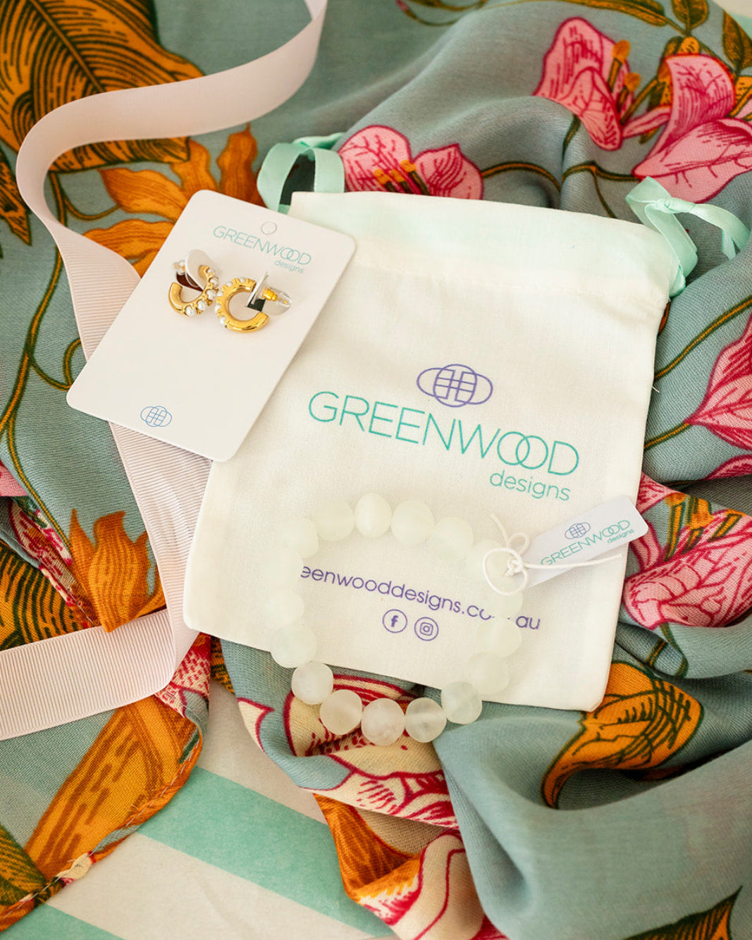 Greenwood Designs product packaging on a floral fabric background