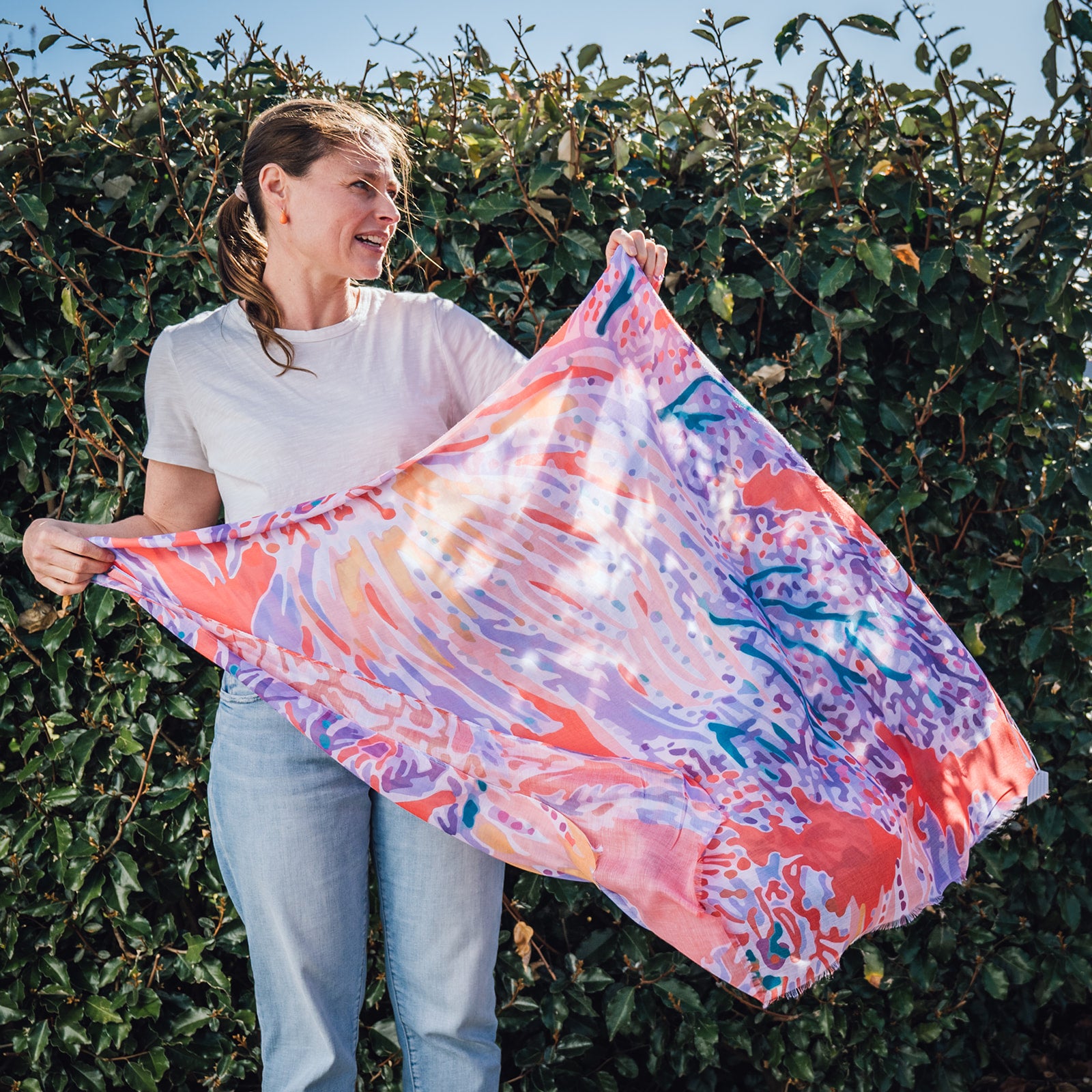 Elevate your style this season with our coral inspired abstract lightweight scarf. Perfect to wear all year round and with a white tee or shirt! It boasts stunning orange, blues and lilac hues. Don't miss this season's must-have accessory!