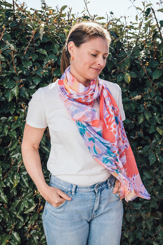 Elevate your style this season with our coral inspired abstract lightweight scarf. Perfect to wear all year round and with a white tee or shirt! It boasts stunning orange, blues and lilac hues. Don't miss this season's must-have accessory!