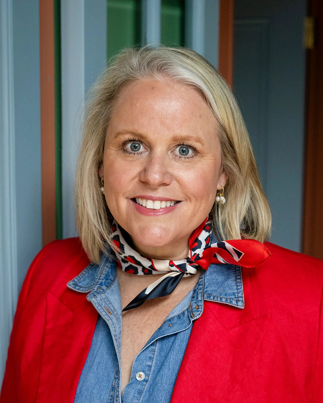 Silk neck scarf in red and black leopard print styled around the neck