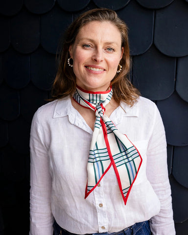 Satin neck scarf and bag tie in red check print styled around the neck