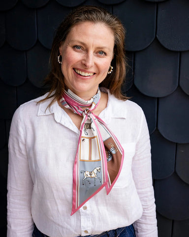 Satin neck scarf and bag tie in pink horse print styled around the neck