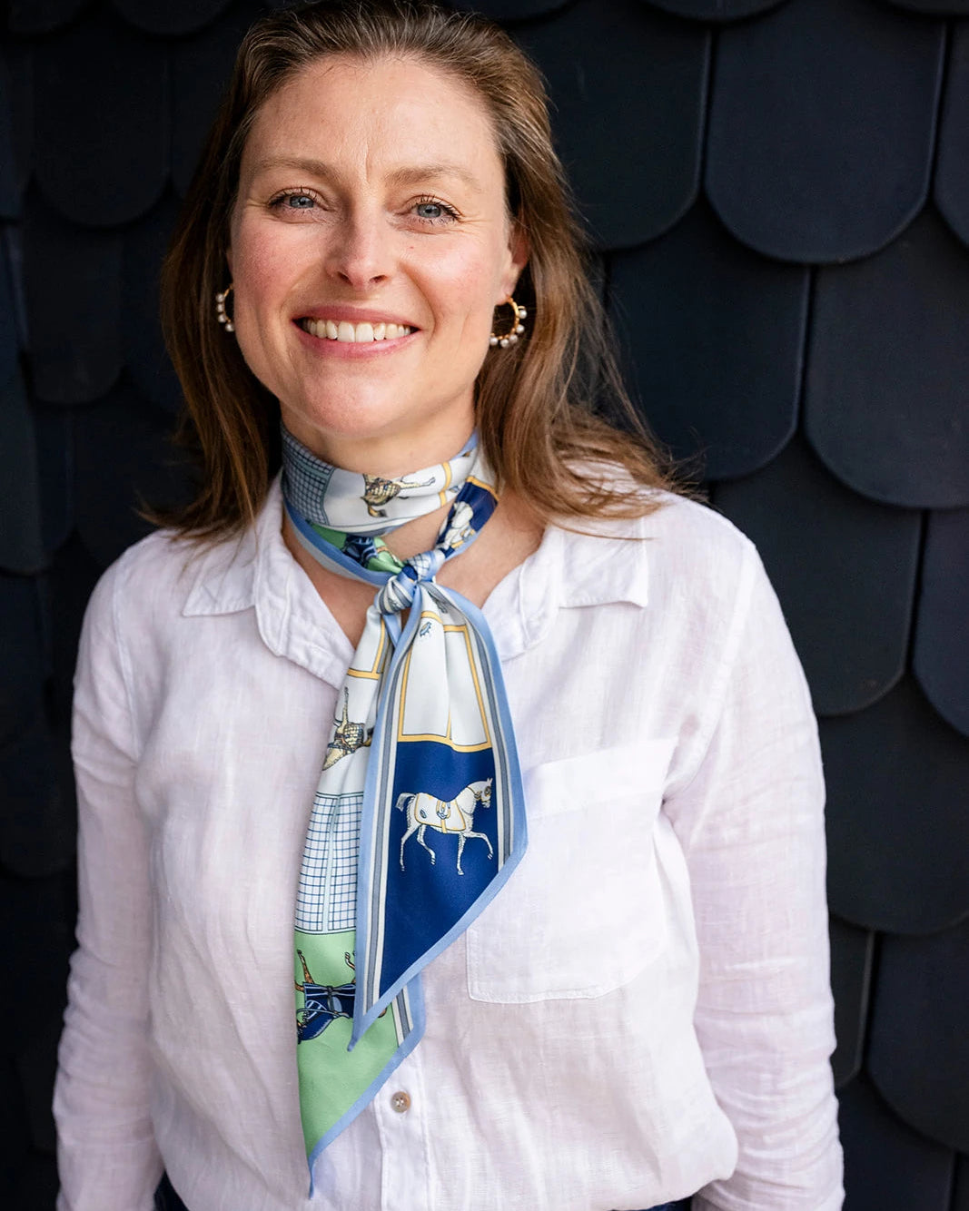 Satin neck scarf and bag tie in blue horse print styled around the neck