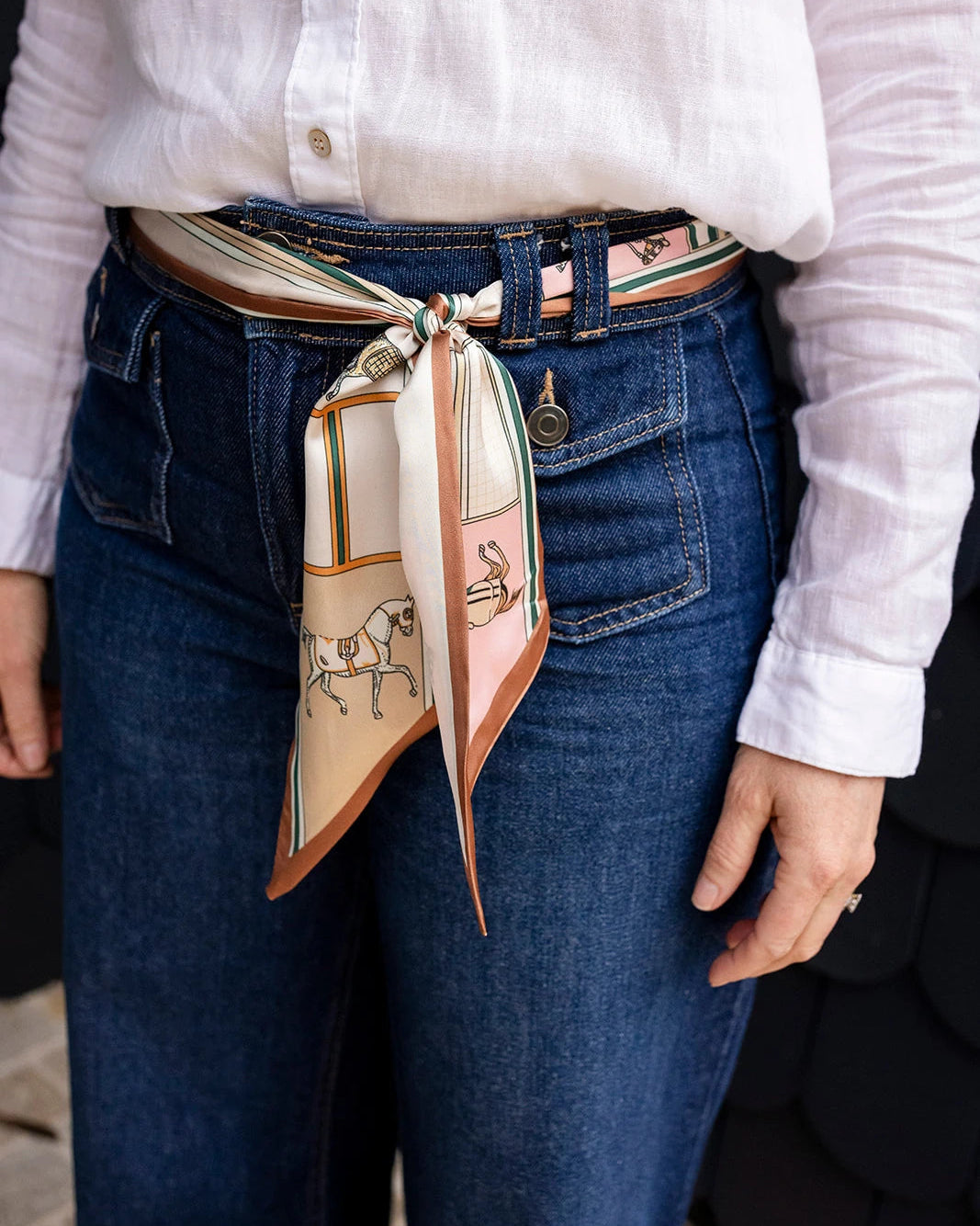 Satin neck scarf and bag tie in beige horse print tied to a handbag handle