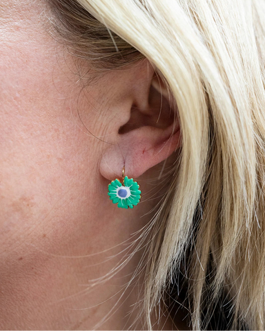 Gold hoop earrings with a green enamel zinnia flower charm and purple centre