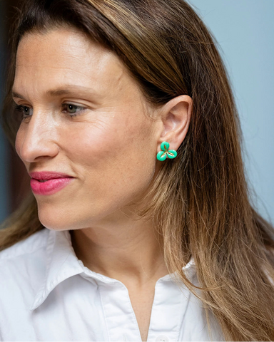 Gold stud earrings with a green enamel three-petal flower design