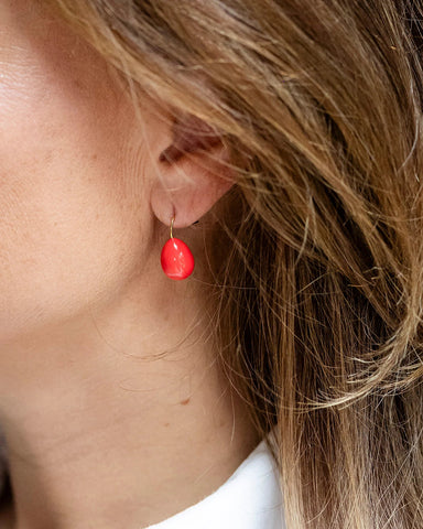 Gold drop earrings with a coral enamel teardrop design