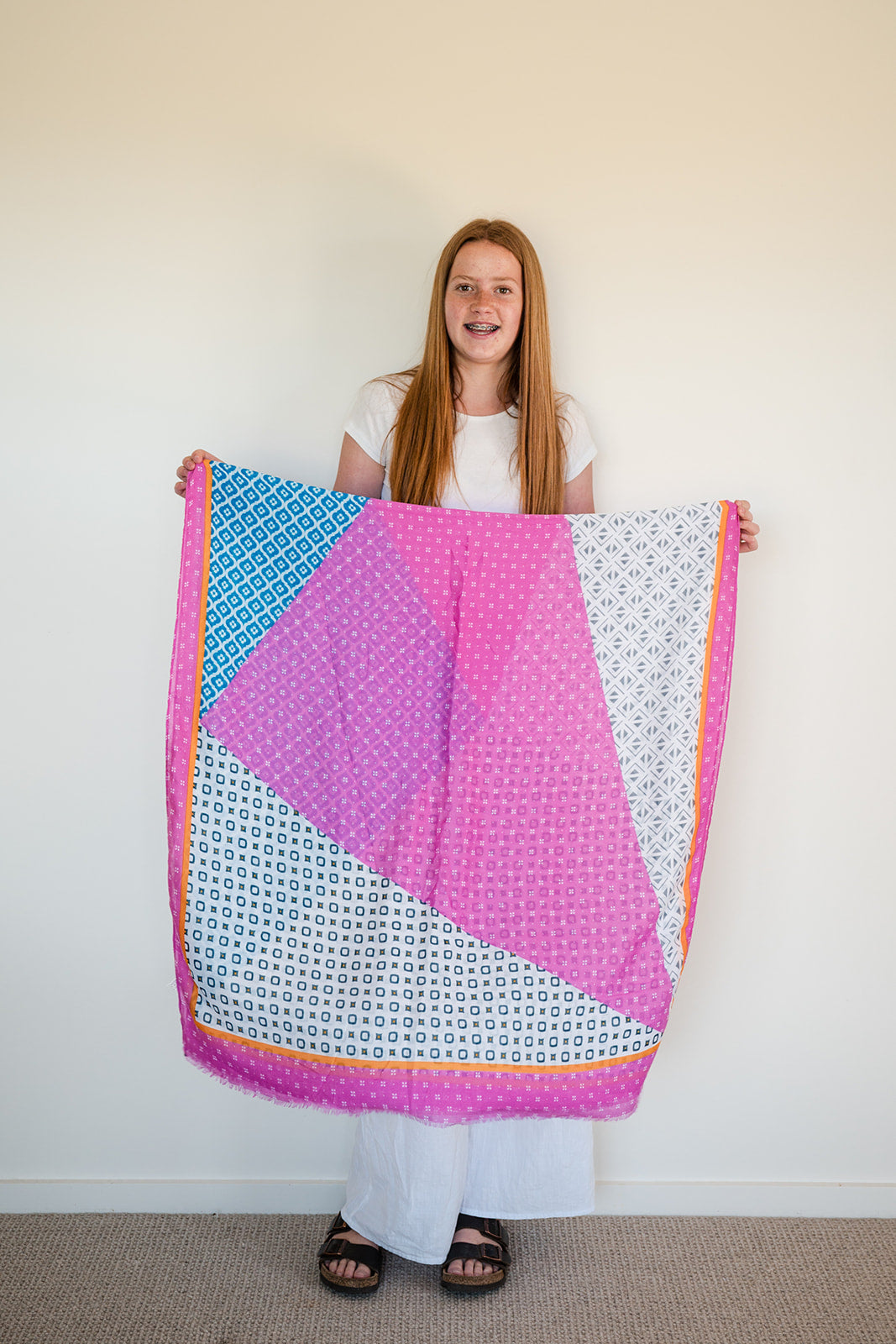 Introducing this geometric scarf – the lightweight, year-round essential that's all about fun and fashion! Featuring a fantastic palette of pinks, blues, orange and white, this scarf is as versatile and the perfect addition to your spring outfits.