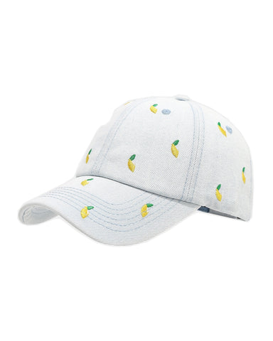 Light-wash denim baseball cap embroidered with small yellow lemons, front view on a white background.