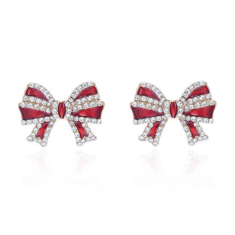A pair of gold bow stud earrings with red enamel ribbons outlined in clear crystals.