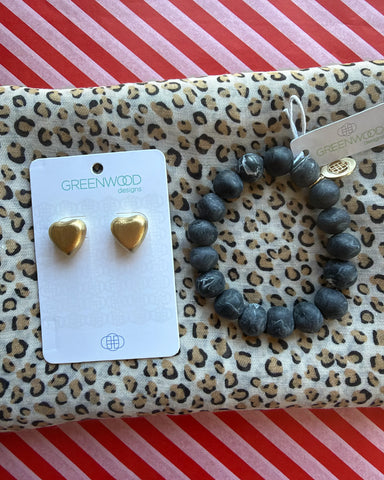 Flat lay of the Sasha leopard print scarf, the Black Marble rock bracelet and Harper Heart earrings in Gold, puffed gold heart studs, on a Greenwood Designs card.
