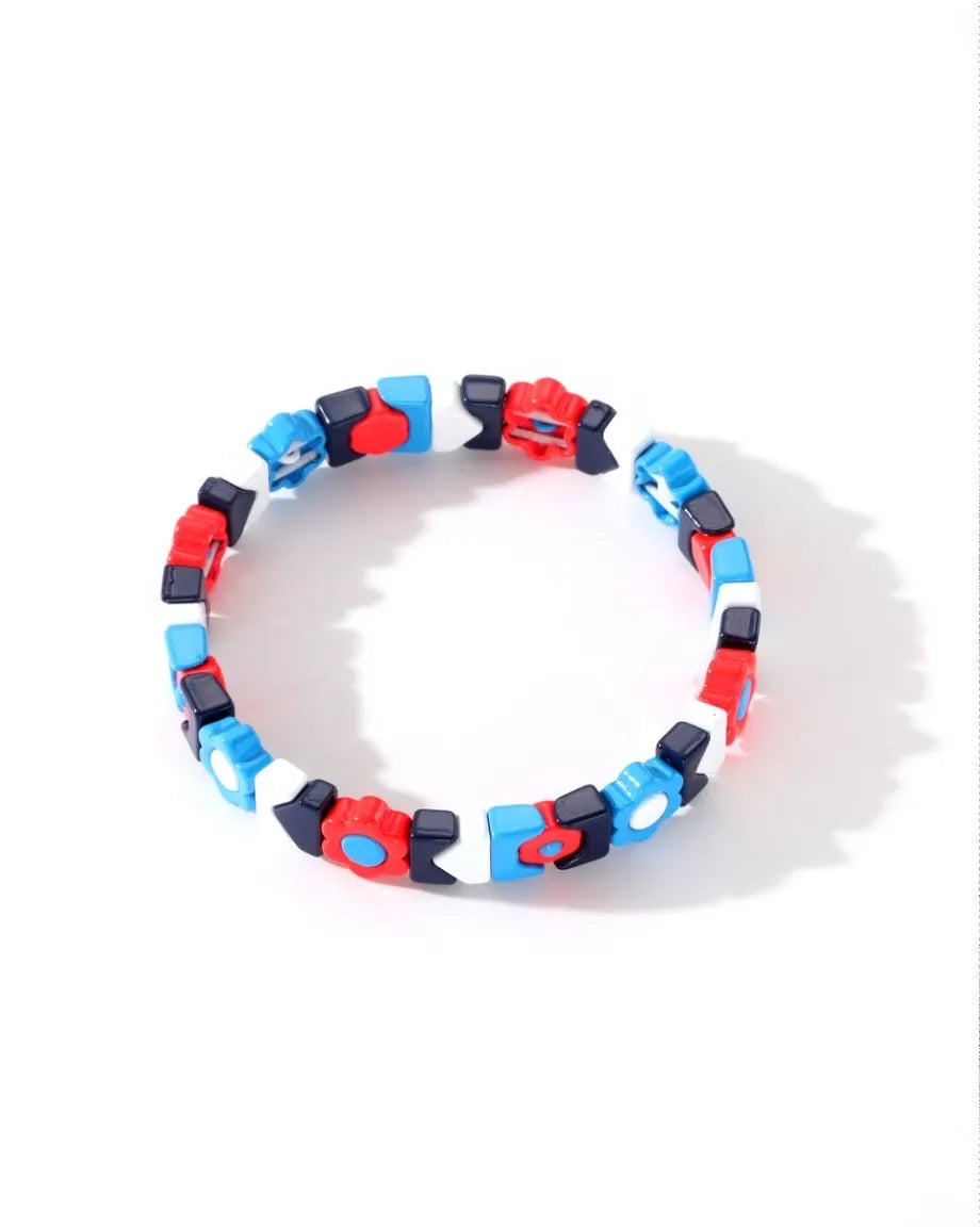 Colorful bracelet with red, blue, and black beads on a white background