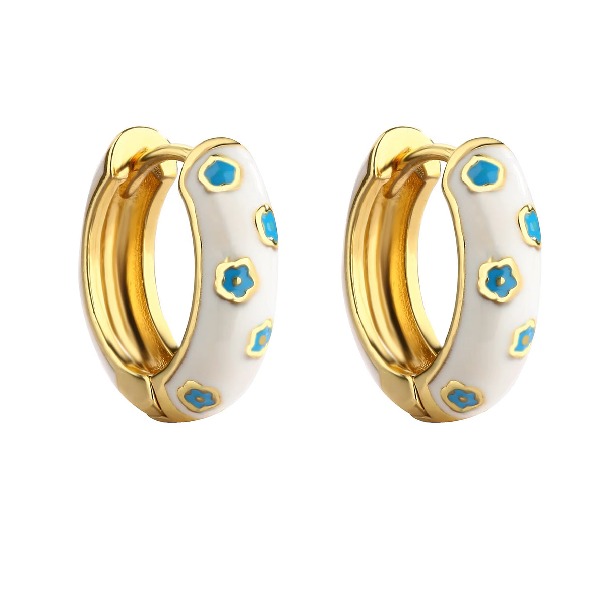 White and gold enamel hoop earrings with blue flower pattern on white background