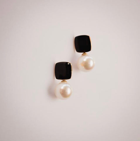 Felicity black enamel square stud earrings with faux pearl drop by Greenwood Designs, shown on neutral background