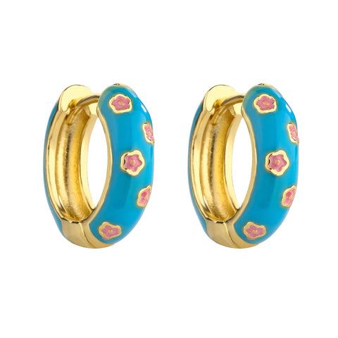 Blue and gold enamel hoop earrings with pink flower pattern on white background