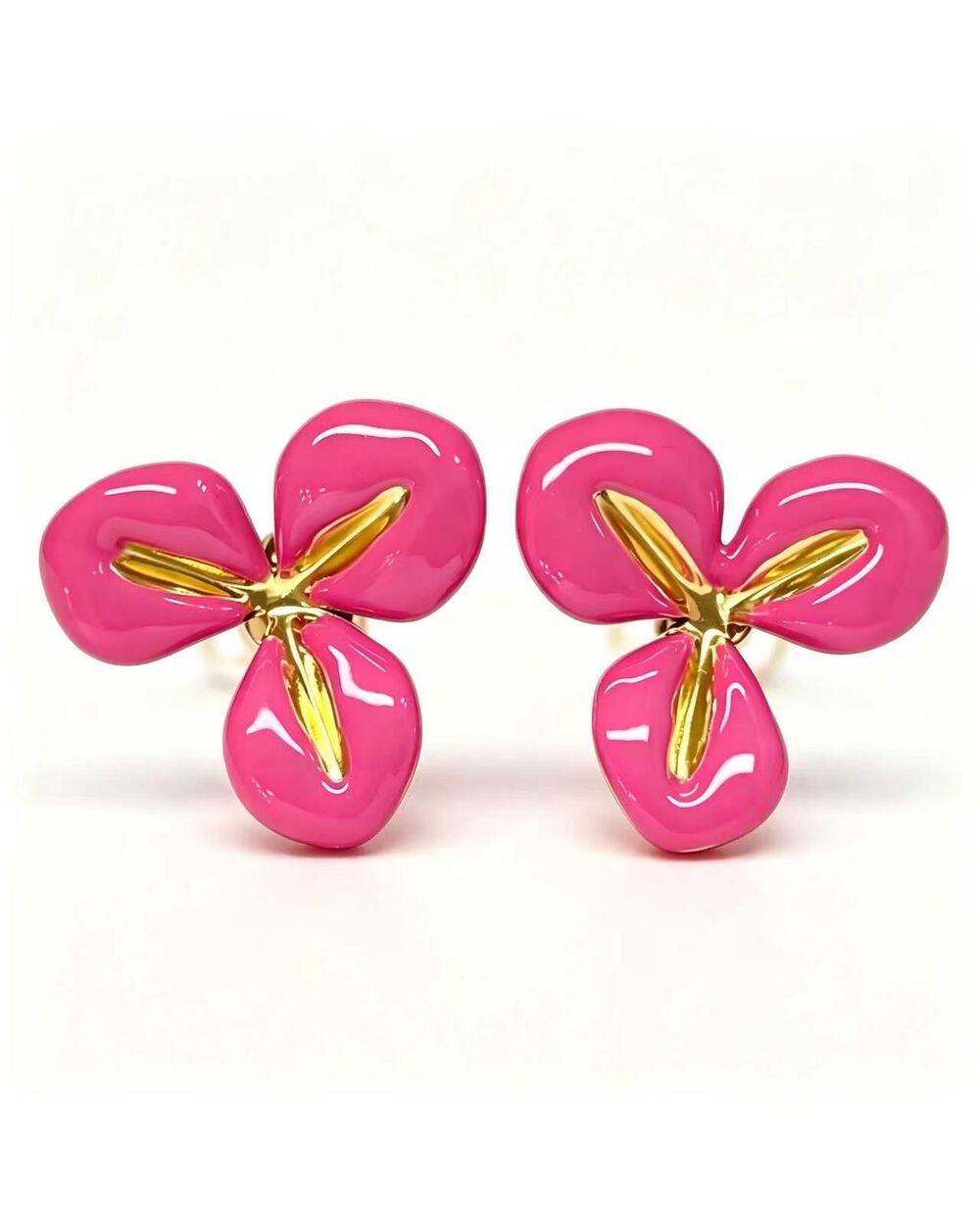 Gold stud earrings with a hot pink enamel three-petal flower design