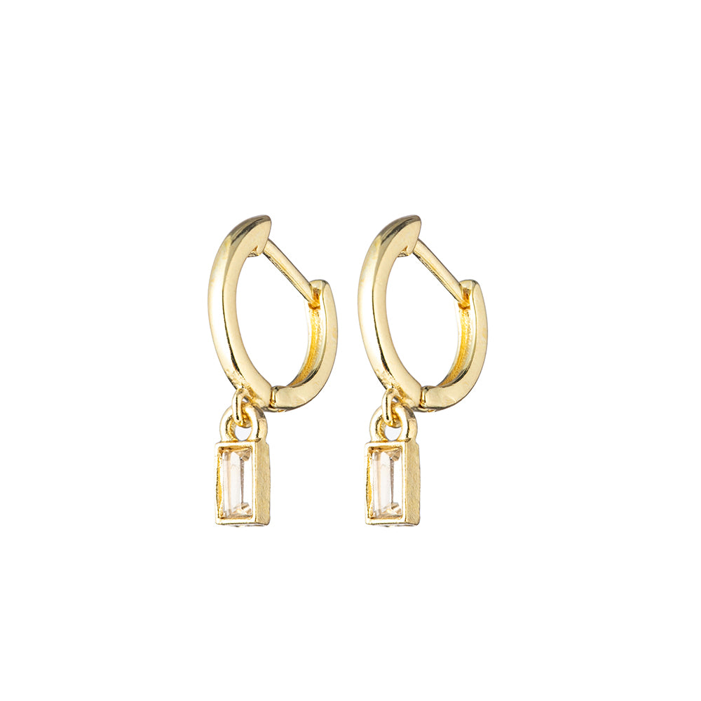 Gold hoop earrings with clear crystal dangle on white background