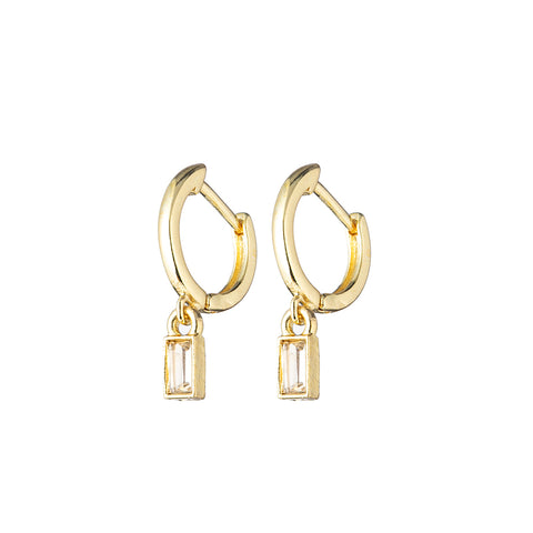 Gold hoop earrings with clear crystal dangle on white background