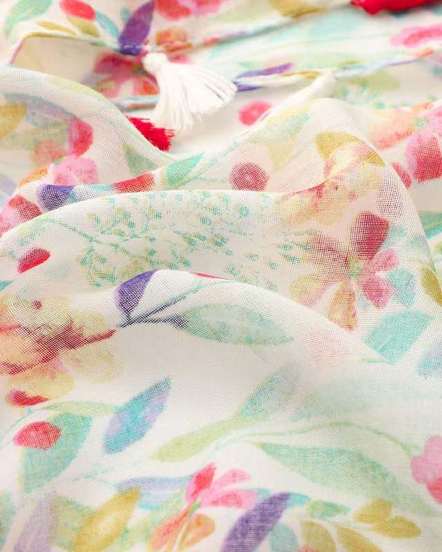 Close-up of pastel multicolour floral print on lightweight scarf fabric with tassel
