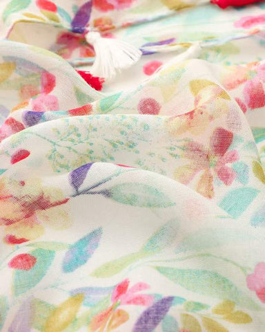 Close-up of pastel multicolour floral print on lightweight scarf fabric with tassel