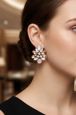 Woman wearing Peta soft pink crystal cluster stud earrings by Greenwood Designs, styled with a black top in an elegant indoor setting