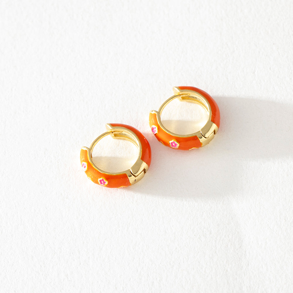Jane orange enamel chunky hoop earrings with pink floral detail by Greenwood Designs, shown on white background