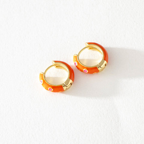 Jane orange enamel chunky hoop earrings with pink floral detail by Greenwood Designs, shown on white background