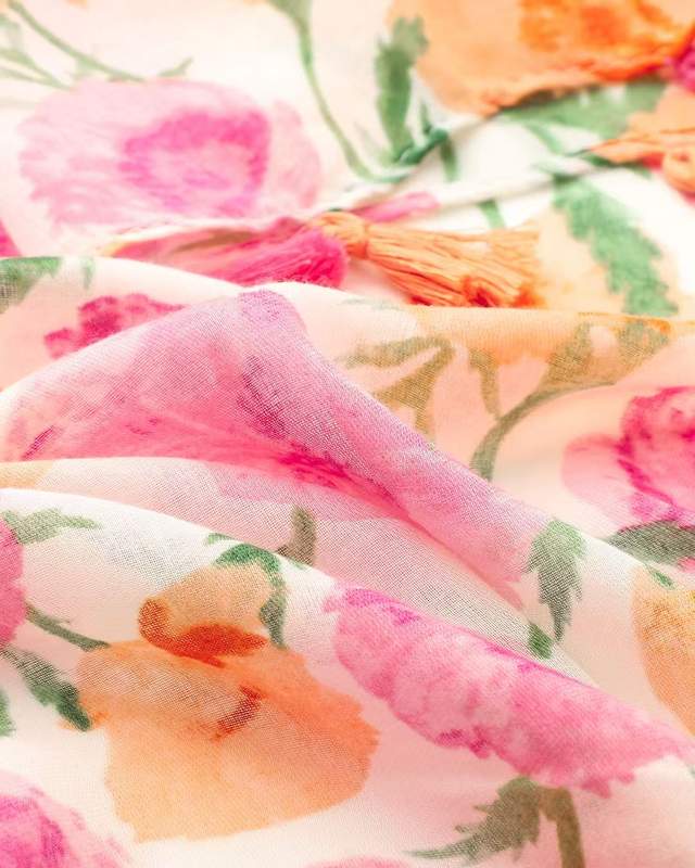 Close-up of coral pink and orange watercolour floral print on lightweight scarf fabric