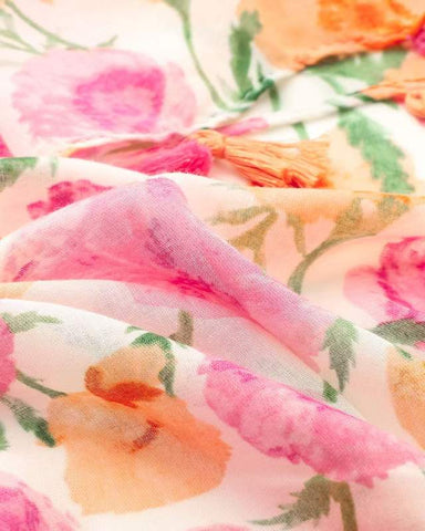 Close-up of coral pink and orange watercolour floral print on lightweight scarf fabric