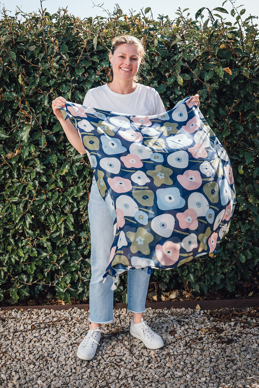 Step into style with our abstract flower scarf! This lightweight beauty is your year-round companion, featuring delightful tassels on each end for added texture. The navy base adorned with pink, blue, and olive green abstract flowers adds a touch of sprin