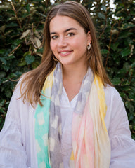 Elevate your style with our beautiful lattice pattern scarf, adorned with soft pastel colors of aqua, yellow, pink, and lilac. The cream center panel adds an elegant touch and balance to the design, while frayed edges provide texture and a casual feel. Lightweight and versatile, this scarf is the perfect accessory for creating a dreamy and feminine look. Crafted from a comfortable polyester blend.