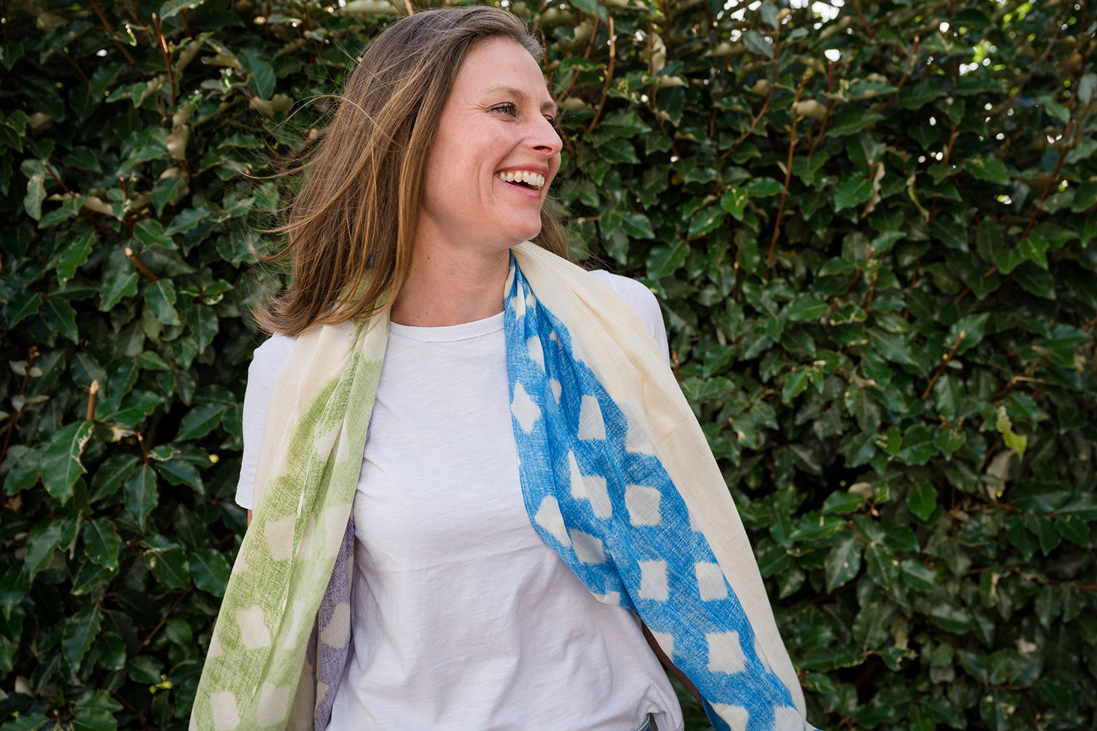 Make a statement with our lattice pattern scarf, blending bright blue, navy, purple, and lime tones. The cream center panel adds sophistication and balance to the design, while frayed edges provide texture and a casual feel. Lightweight and versatile, this scarf is the perfect accessory for adding a pop of color to any outfit. Crafted from a comfortable polyester blend.