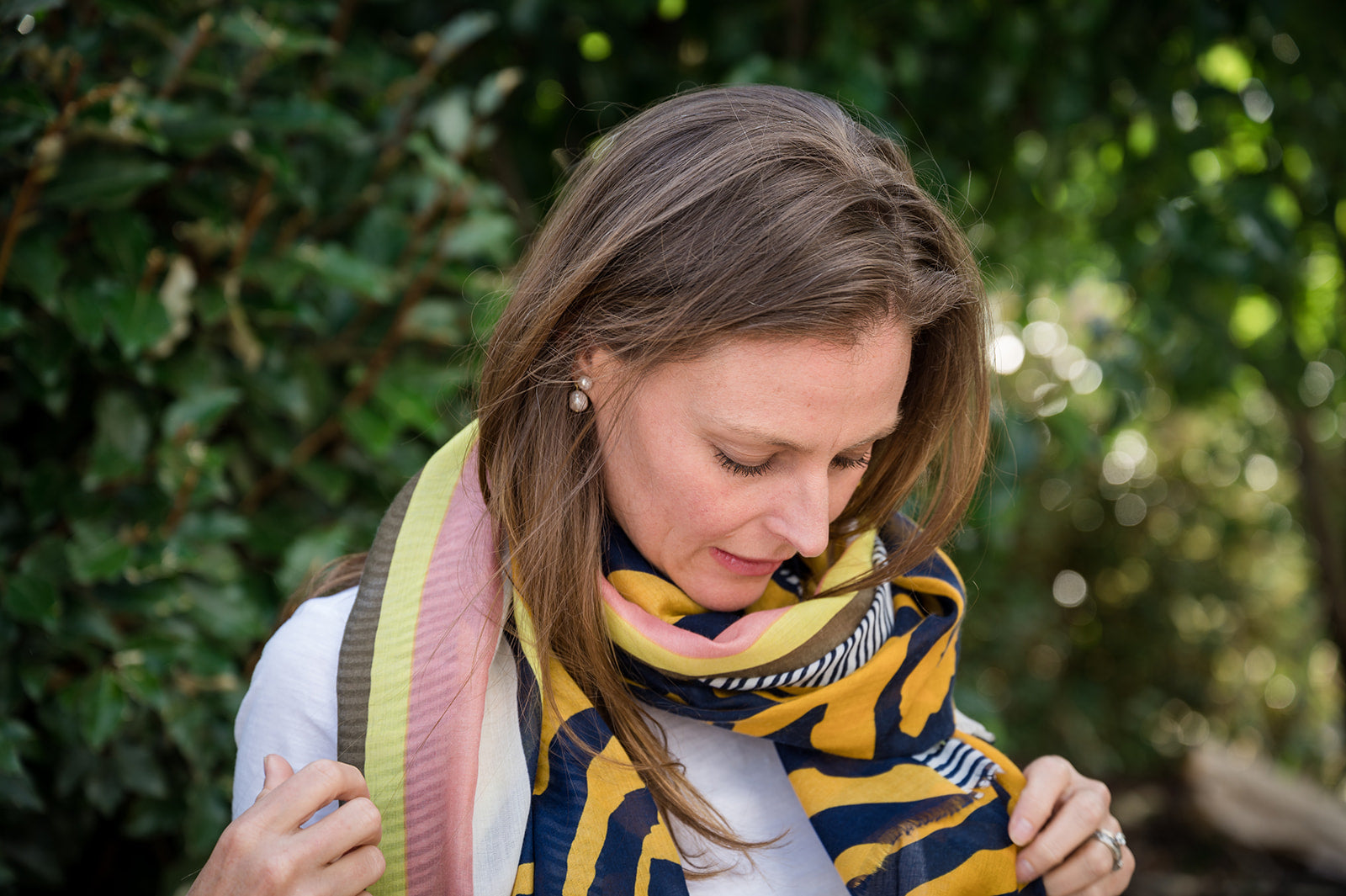 Elevate your style with our bold geometric animal print scarf, a must-have statement accessory. The mesmerizing blend of mustard, navy, pink, and yellow tones creates a chic and modern look. Finished with frayed edges for added texture and a casual vibe, this versatile and lightweight scarf is perfect for turning heads wherever you go. All scarves are crafted from a comfortable polyester blend.