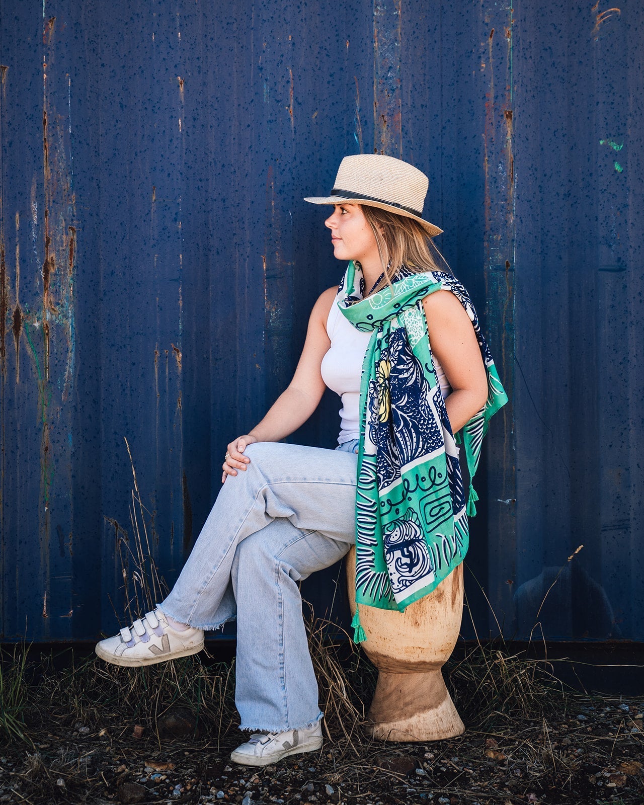 Alana Aloha Women's Scarf: Island-inspired motif in navy, white, and yellow on emerald green, with lively emerald green tassels. Embrace tropical vibes and elevate your style effortlessly!