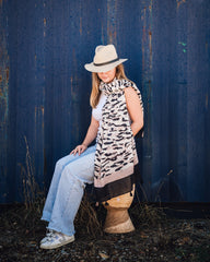 Eve Animal Print Women's Scarf: Fierce and stunning animal print in black, pink, and nude tones on a creamy canvas. Stylish pink and black border on each end with alternating pink and black tassels for an extra touch of flair. Polyester blend for a soft a