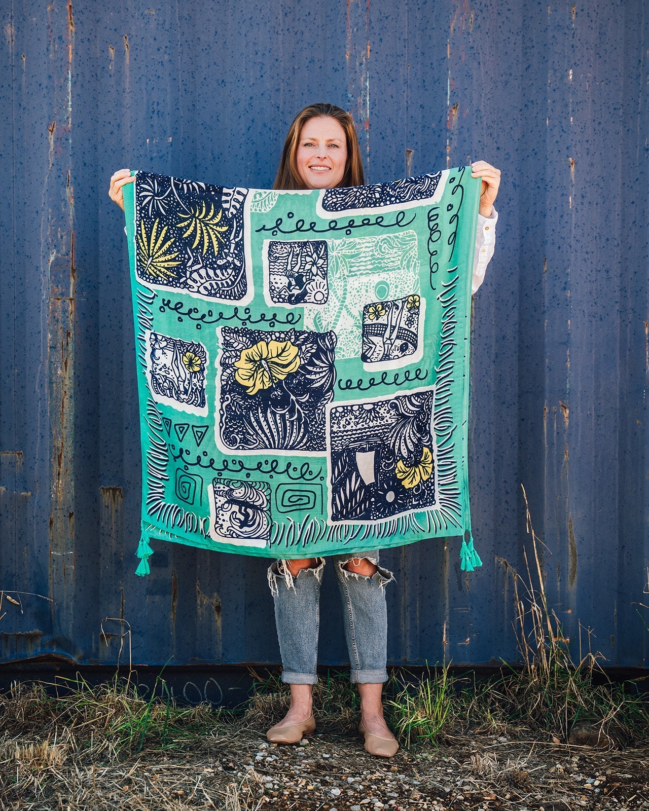 Alana Aloha Women's Scarf: Island-inspired motif in navy, white, and yellow on emerald green, with lively emerald green tassels. Embrace tropical vibes and elevate your style effortlessly!