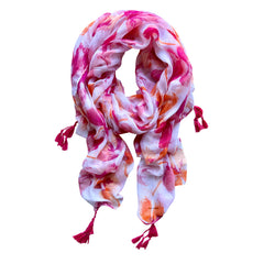 Elevate your style with our stunning hibiscus-inspired scarf, adorned with vibrant pink and orange tones on a white base. Hot pink tassels at each corner add a playful touch. Lightweight and perfect for year-round wear. Crafted from a comfortable polyester blend.