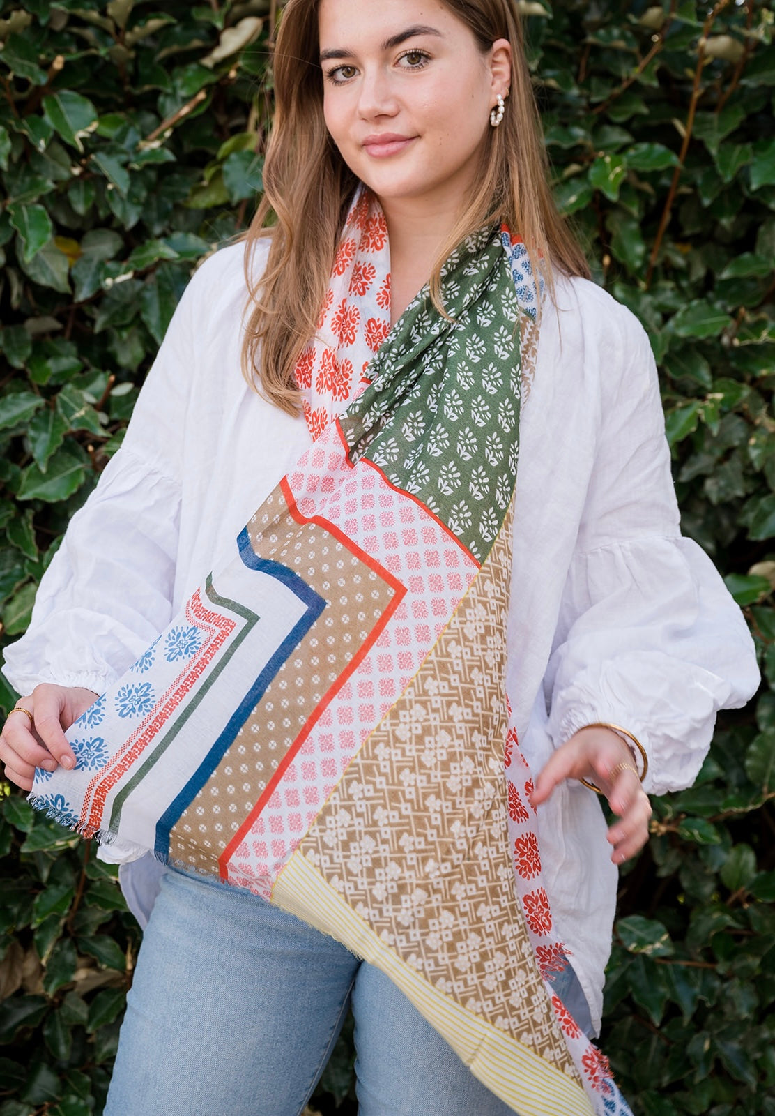 Elevate your style with our abstract scarf featuring a beautiful mosaic-like pattern in harmonious blues, greens, neutrals, and a pop of terracotta. The intricate design is complemented by frayed edges, giving it a relaxed and bohemian feel. The mix of cool and earthy tones creates a soothing and balanced look, making it perfect for any occasion. Crafted from a comfortable polyester blend.
